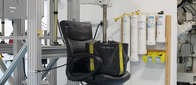 A weight sits on an office chair as part of testing